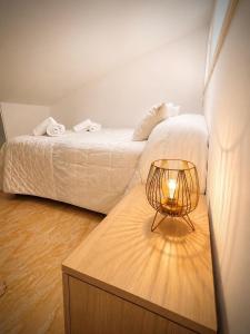 a bedroom with a bed and a table with a lamp at Casa Rural San Gregorio in Alcalá del Júcar