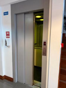 an elevator in a building with a sign on it at Hospedaria Insular in Ponta Delgada