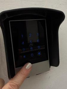 a person holding a remote control in a microwave at Hospedaria Insular in Ponta Delgada +9 photos