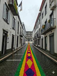 a street with a colorful stripe on the road at Hospedaria Insular in Ponta Delgada