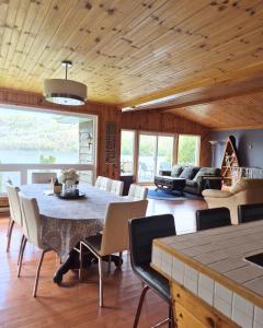a living room with a large table and chairs at Chalet l'Apero in Val-des-Bois