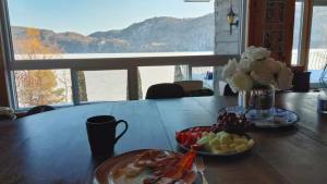 a table with a plate of food and fruit on it at Chalet l'Apero in Val-des-Bois +44 photos