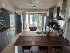 a kitchen with a large sink and a counter top at The Bach - beachfront in Waimarama +7 photos