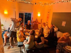 a group of people sitting around a living room at ITH San Diego Mission Beach Backpacker Hostel in San Diego