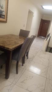 a wooden table and chairs in a room at Hotel Casa Victoria in Tequila