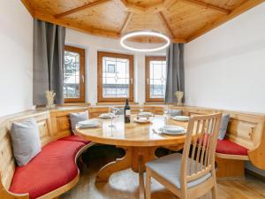 a dining room with a wooden table and chairs at An der Ache XL in Kirchberg in Tirol