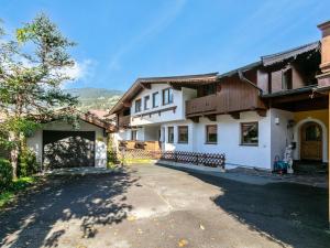 a large white house with a driveway at An der Ache XL in Kirchberg in Tirol
