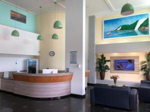 a lobby with a reception desk and couches at Ponta Negra Flat 305 in Natal