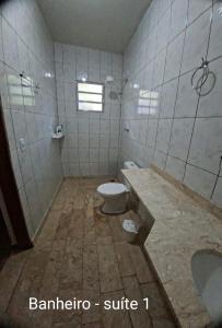a bathroom with a toilet and a sink and a tub at Chácara Solar de Jarinu in Jarinu +17 photos