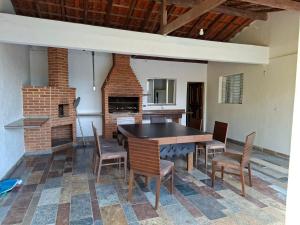 a dining room with a table and chairs at Chácara Solar de Jarinu in Jarinu