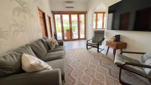 a living room with a couch and a television at Villa Alam in Nusa Lembongan