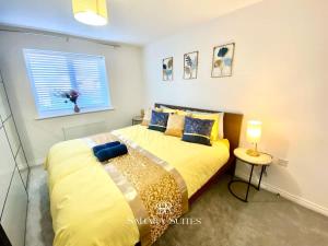 a bedroom with a bed with yellow sheets and a window at 4 Bed House with Driveway Parking for 2 Cars - Rugby - Sleeps 10! Perfect for groups! in Rugby +29 photos
