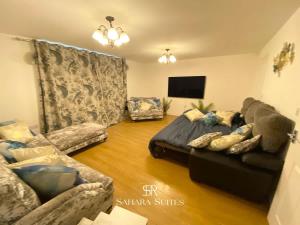 a living room with a bed and a couch at 4 Bed House with Driveway Parking for 2 Cars - Rugby - Sleeps 10! Perfect for groups! in Rugby