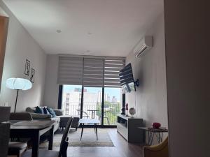 a living room with a couch and a table at Guadalajara American visa - 2 bedrooms in Milpillas