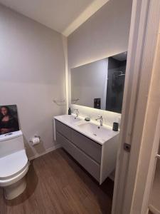 a bathroom with a white sink and a toilet at Guadalajara American visa - 2 bedrooms in Milpillas +28 photos