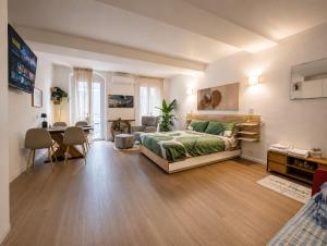 a bedroom with a bed and a living room with a table at TIMELESS HOME Deluxe Cinema Suite in Parma