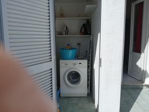 a washer and dryer sitting in a hallway at CASA Pitosforo CASA Ulivo in Forio d'Ischia