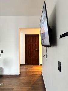 a flat screen tv hanging on a wall in a room at Demi Apartment in Zaachila