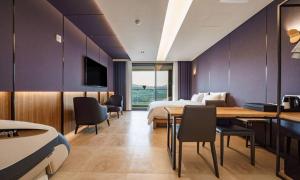 a hotel room with a bed and a table and chairs at Anseong Nomad Hotel in Anseong +58 photos