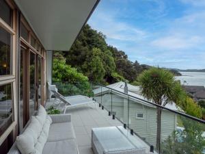a balcony of a house with a view of the water at Moana View in Paihia