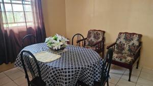a dining room with a table and two chairs at Smithy's Apartment 1 in Brighton Village +3 photos