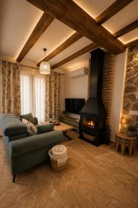 a living room with a couch and a fireplace at Al Zahra Suites in Zahara de la Sierra