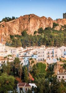 a group of buildings on the side of a mountain at Al Zahra Suites in Zahara de la Sierra