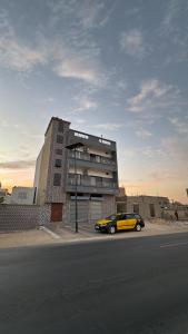 a yellow car parked in front of a building at Résidence NDAR in Saint-Louis