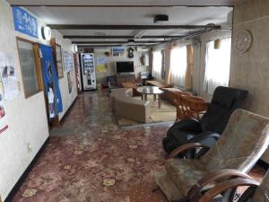 a living room with a couch and chairs at Ebeotsu Onsen in Takikawa +14 photos