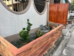 a wooden fence in front of a building with two mirrors at Melinda place in Camarin +8 photos