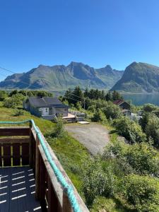 a view of a hill with a lake and mountains at Ryten View Retreat in Hovdan