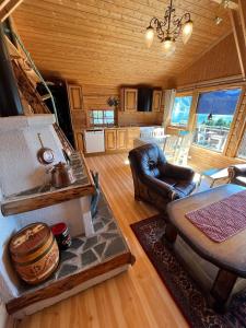 a living room with a couch and a table at Ryten View Retreat in Hovdan
