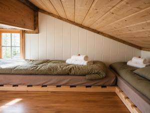 two beds in the corner of a room at Ryten View Retreat in Hovdan