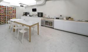 a large kitchen with a table and chairs in it at Anyang ILLOWA Hotel in Anyang