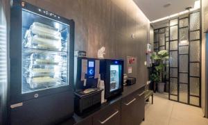 a refrigerator full of dishes in a room at Anyang ILLOWA Hotel in Anyang