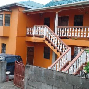 a house with a staircase in front of it at Smithy's Apartment 1 in Brighton Village