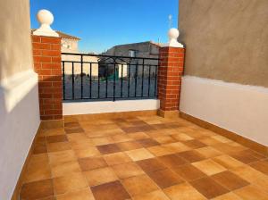 an empty balcony with a view of a building at Casa Rural San Gregorio in Alcalá del Júcar