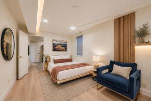 a bedroom with a bed and a blue chair at Pet Friendly! Elevation 25 in Park City +67 photos