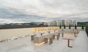 a group of benches and tables on top of a building at Brown Dot Hotel Andong Taehwa in Andong