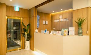 a lobby with a counter in a building at Brown Dot Hotel Andong Taehwa in Andong