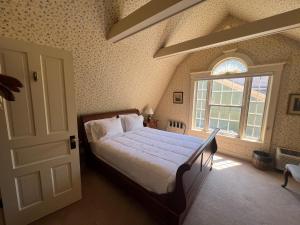 a bedroom with a large bed and a window at Strawtown Inn & Events in Pella