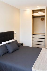 a bedroom with a large bed and a closet at Malladoura Passive House in Porriño