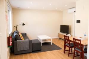 a living room with a couch and a table at Malladoura Passive House in Porriño