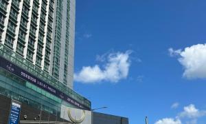 a tall building with a sign in front of it at Centum City Hotel in Busan
