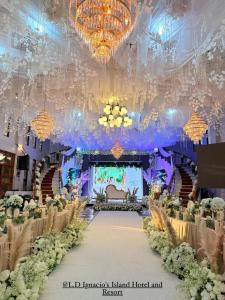 a banquet hall with a aisle with flowers and chandeliers at LD Ignacio Island Resort in Roxas