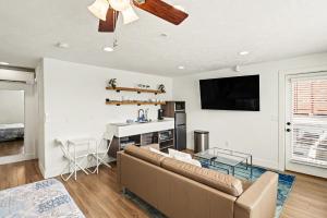 a living room with a couch and a table at Downtown Omaha - Elevated Studio & 1-Bed Stays in Omaha
