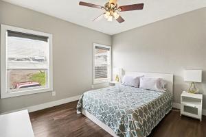 a bedroom with a bed and a ceiling fan at Downtown Omaha - Elevated Studio & 1-Bed Stays in Omaha