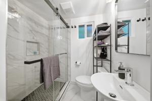 a white bathroom with a sink and a toilet at Venice Venice in Los Angeles +57 photos