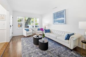 a white living room with a white couch and blue pillows at Venice Venice in Los Angeles
