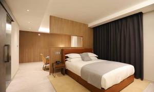 a bedroom with a large bed in a room at Dongdaegu Station Eastern Hotel in Daegu +59 photos
